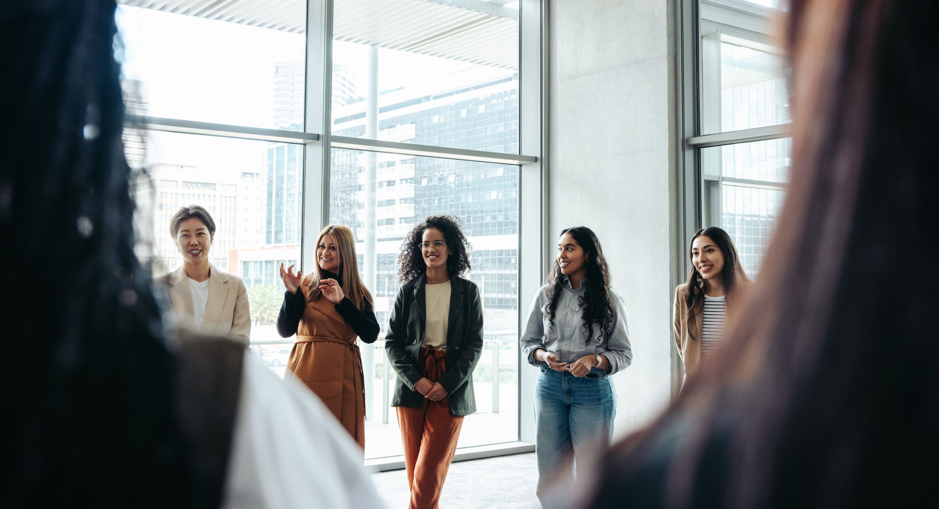 Group of women networking at a corporate event in a modern office building