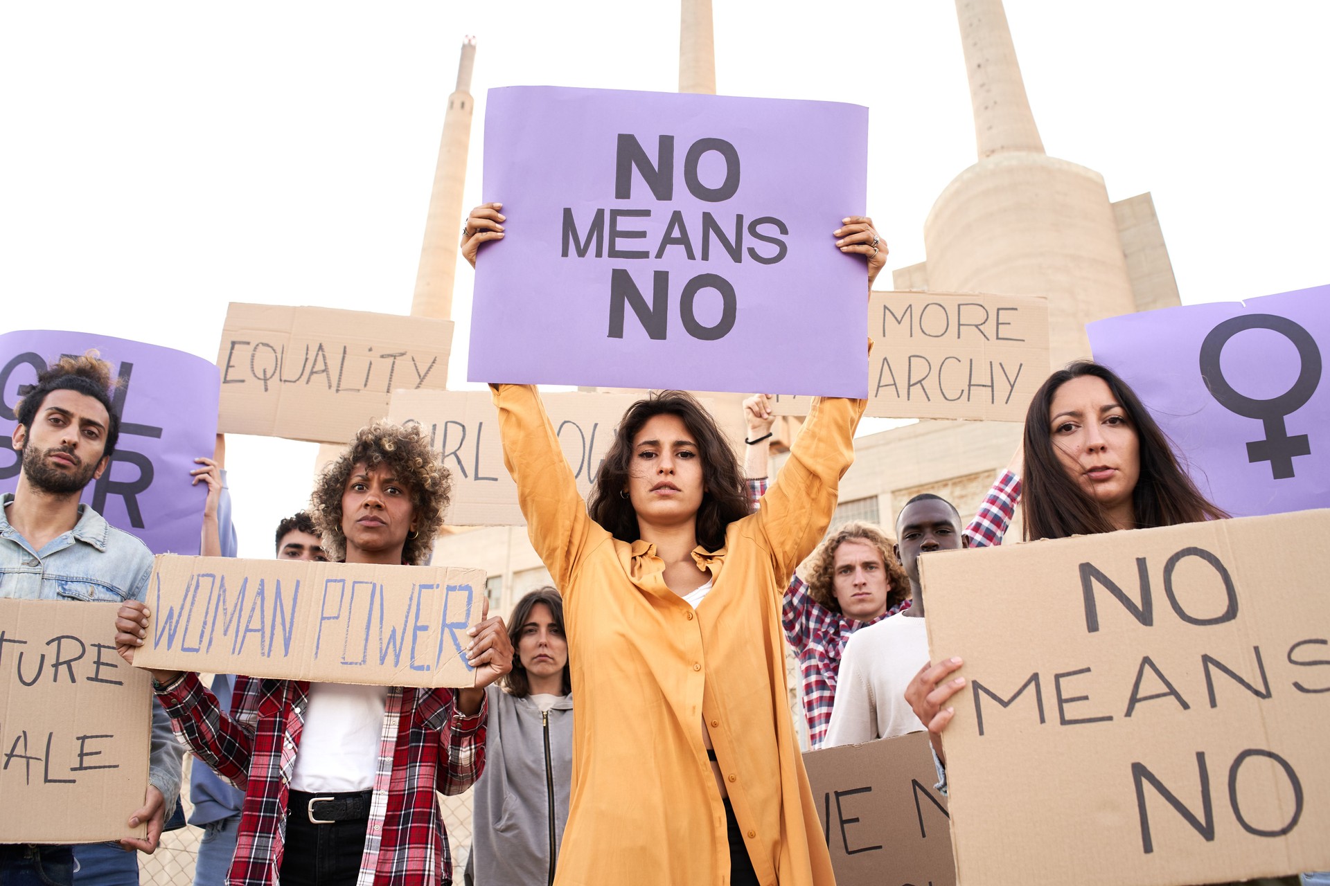 Multiethnic feminist holding banners. Placards with feminist slogans.